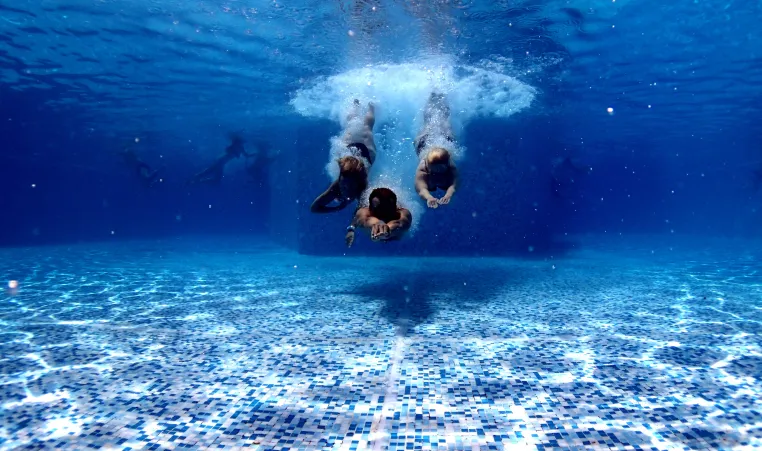 Underwater photo of three people diving