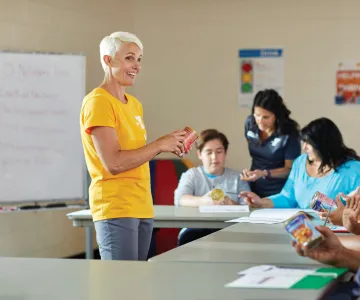 Staff showing a group of participants the ingredients on a can food item