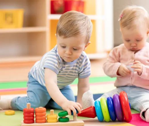 Nursery babies playing with educational toys in creche, early learning