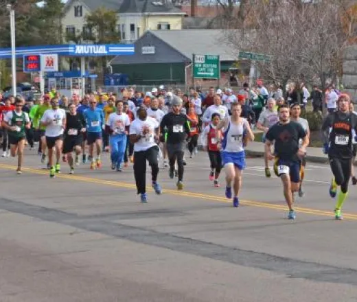 Turkey Trot runners in the road trying to finish a fundraising race